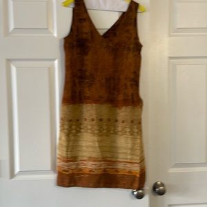 Sleeveless A-line dress with zipper in back.